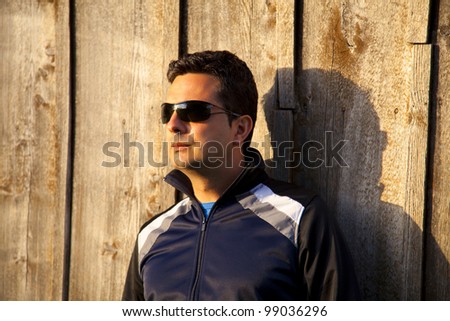 Serious man with sunglasses and sport wear