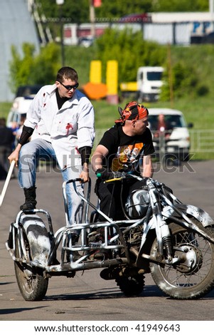 MOSCOW  - JUNE 6 : Stunt man Ilya Sparov (L) gets ready for a stunt trick on bike during a stunt man show June 6, 2008  in Moscow.