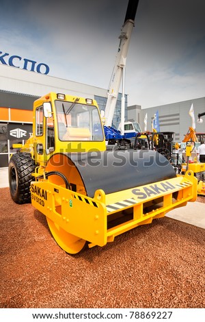 MOSCOW, RUSSIA - JUNE 02:  Orange asphalt campactor on display at Moscow International exhibition Construction equipment and technologies on JUNE 02, 2010 in Moscow, Russia.