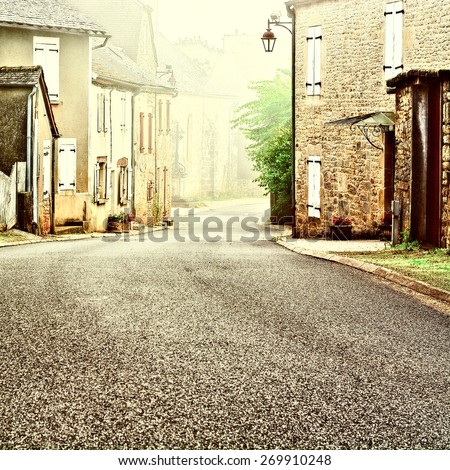French Village Street in the Morning Mist, Vintage Style Toned Picture