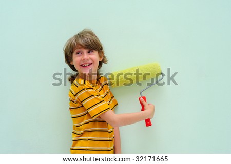 Teen With Roller Against The Light Green Wall.