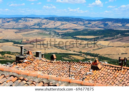 Old Broken Tile Roof Against Tuscan Landscape