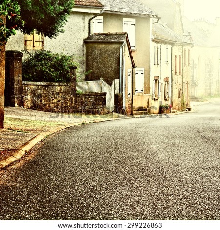 French Village Street in the Morning Mist, Vintage Style Toned Picture
