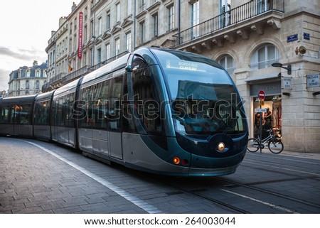 BORDEAUX, FRANCE- June 15 2014: Tram in the center of Bordeaux in France. The Bordeaux tramway network is notable for using a ground-level power supply of the Alimentation par Sol (APS) system.