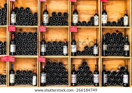 SAINT EMILION, FRANCE -AUGUST 31, 2012: Bottles of wine on the shelves in the wine store