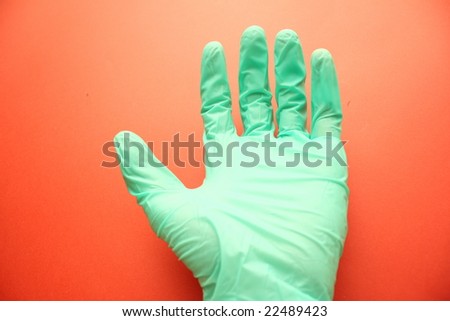 extended arm in the green rubber glove on the background