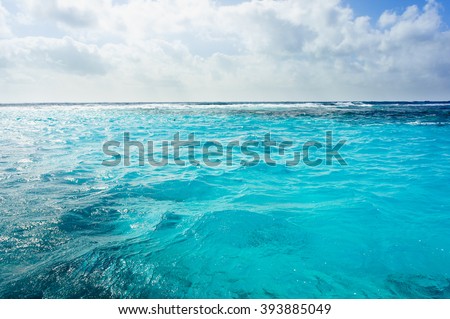 Caribbean summer sea with blue water wave, Cuba. Outdoor tropical summer sea paradise. Heaven view of deep transparent ocean. Sunshine reflection on a calm summer ocean. Tranquility of turquoise water