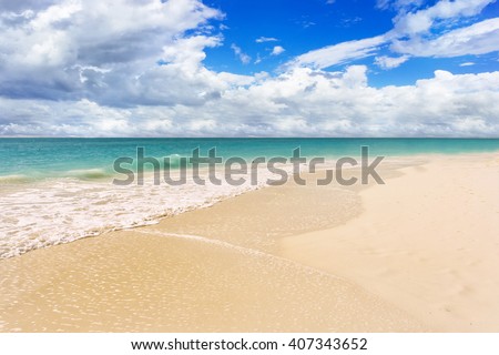 Tropical sand beach in Caribbean sea, Cayo Largo, Cuba. Nobody at beautiful beach. Sea waves, white sand, paradise beach. Island beach with blue water. Sea foam on beach. Paradise beach. Empty beach.
