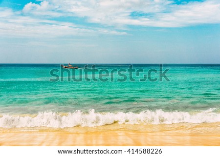 Turquoise sea wave foam on Karon beach, Phuket, Thailand. Thailand sea beach with sea foam, boat and white sand. Beautiful sea wave. Sea waves. Colorful sea. Sea waves near beach. Beautiful sea beach.