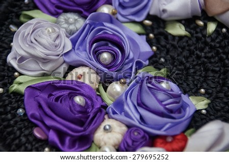 Photo of handmade ribbon violet flowers with beads