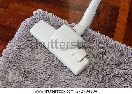 Vacuum cleaner to tidy up on  wooden floor