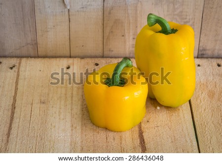 Close up  big yellow sweet peppers  on wooden table