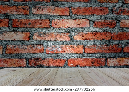 Top wooden table with  brick wall background