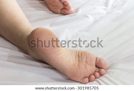Beautiful woman feet on the bed