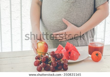 Pregnant woman and healthy food for baby
