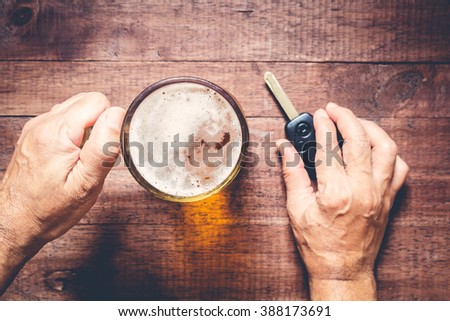 Man hand drinking beer and holding car keys