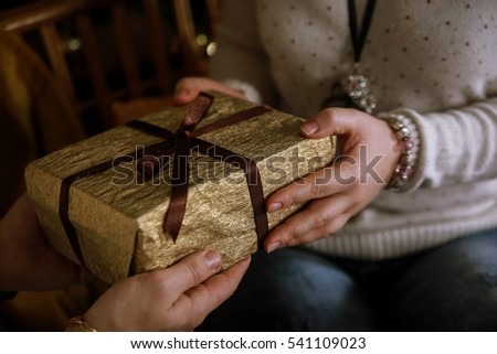 man gives a gift to a woman