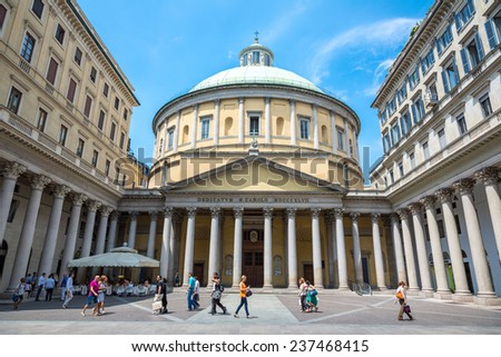 Milan, Italy - June 2012: People walking and seated in an open air bar in front of the San Carlo church