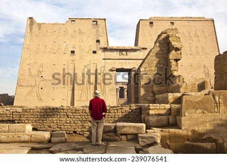 Edfu, Egypt - January 2010: A tourists in the archaeological site looking at the main portal of the temple
