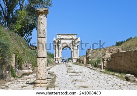 Leptis Magna, Libya - April 2009: Archaeological site, visitors around the Settimio Severo Arch