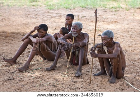 Grashoek, Namibia - December 12 2009: Owamboland, a group of  young and old indigenous people seated in the bushmen village