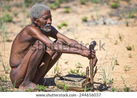 Grashoek, Namibia - December 12 2009: Owamboland, an old indigenous man crouched  in the bushmen village