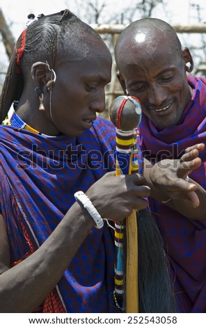 Ngorongoro, Tanzania - September 1 2008: Two Masai people in their village admiring their jewels