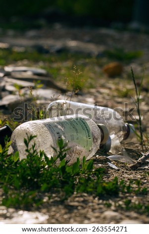 ZAGREB, CROATIA - JUNE 27, 2013: Medical waste, discarded bottles of glucosaline solution in nature.