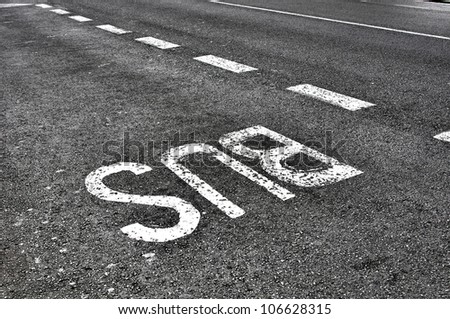 Bus lane sign painted on tarmac road
