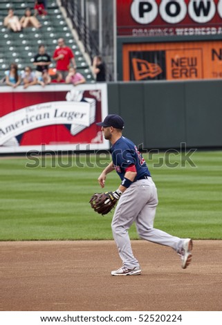 BALTIMORE - May 1: Dustin Pedroia of the Boston Red Sox plays catch before a game at Camden Yards on May 1st, 2010 in Baltimore, Maryland