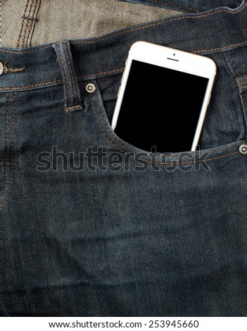 white smart phone in pocket with black screen. Lying on jeans