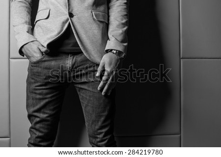 Black and White Color Businessman in gray suite,jeans. Part of body. On beige color background
