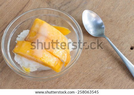 mango with rice stick and coconut milk thai dessert in summer on wood background