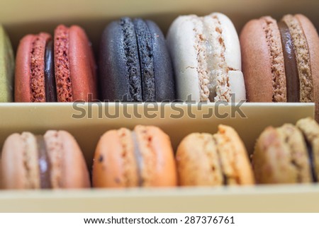traditional french sweet dessert colorful delicious macarons in a rows in a box focus on top