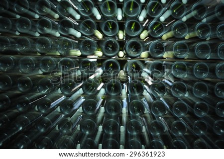 Wine bottles stored in dark winery