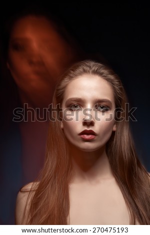 Fashion model portrait with mixed light in two faces