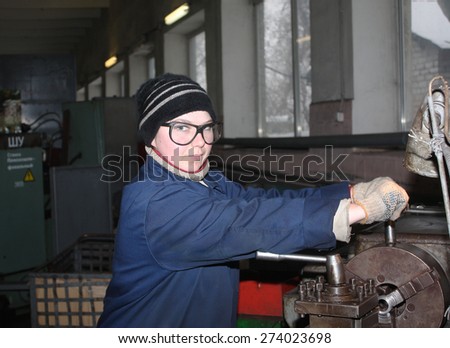Ukraine, Makeevka, - January, 29, 2013: The girl at the lathe turner. Plant for the production of fire extinguishers \