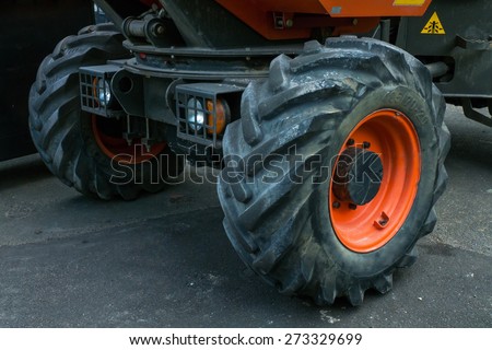 Big wheels of a dump truck on a tarmac.