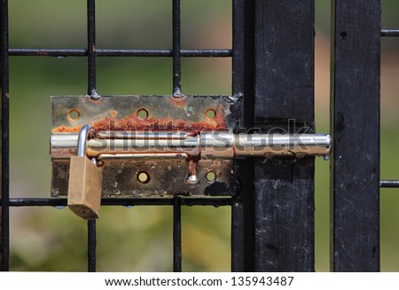 Picture of an old padlock on a metal door
