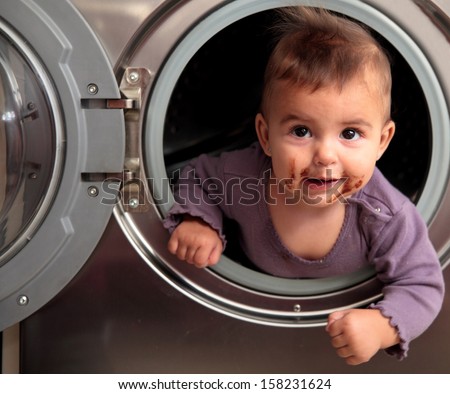 dirty baby inside a washer
