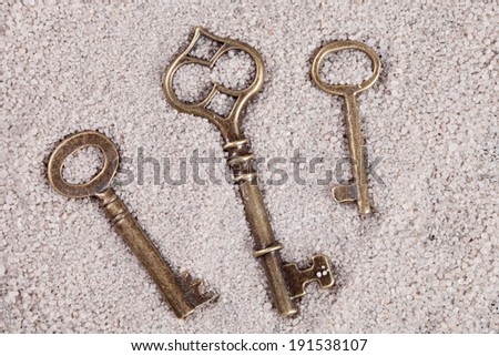 old vintage keys on the sand