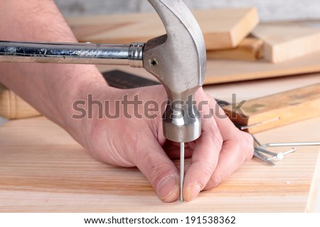 detail of a nail and a hammer