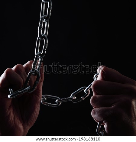 human hands taking a chain