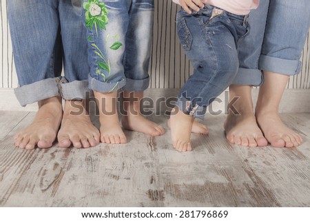 dad, mom and daughters barefoot with jeans