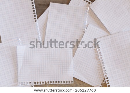 Some sheets of grid paper over a wooden surface