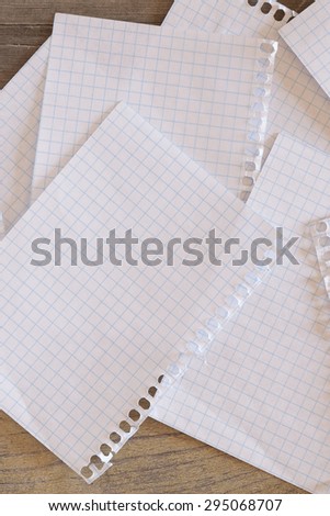 Some sheets of grid paper over a wooden surface
