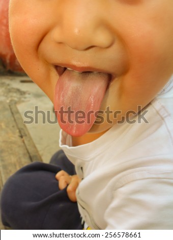 a boy with tongue sticking out