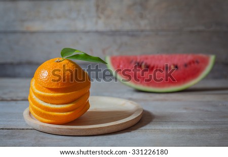 Orange and watermelon on wood table background sill life.