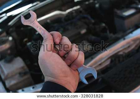 Wrench in the hand of auto mechanic