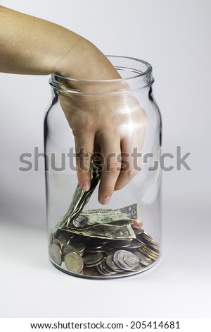 Hand in the money jar